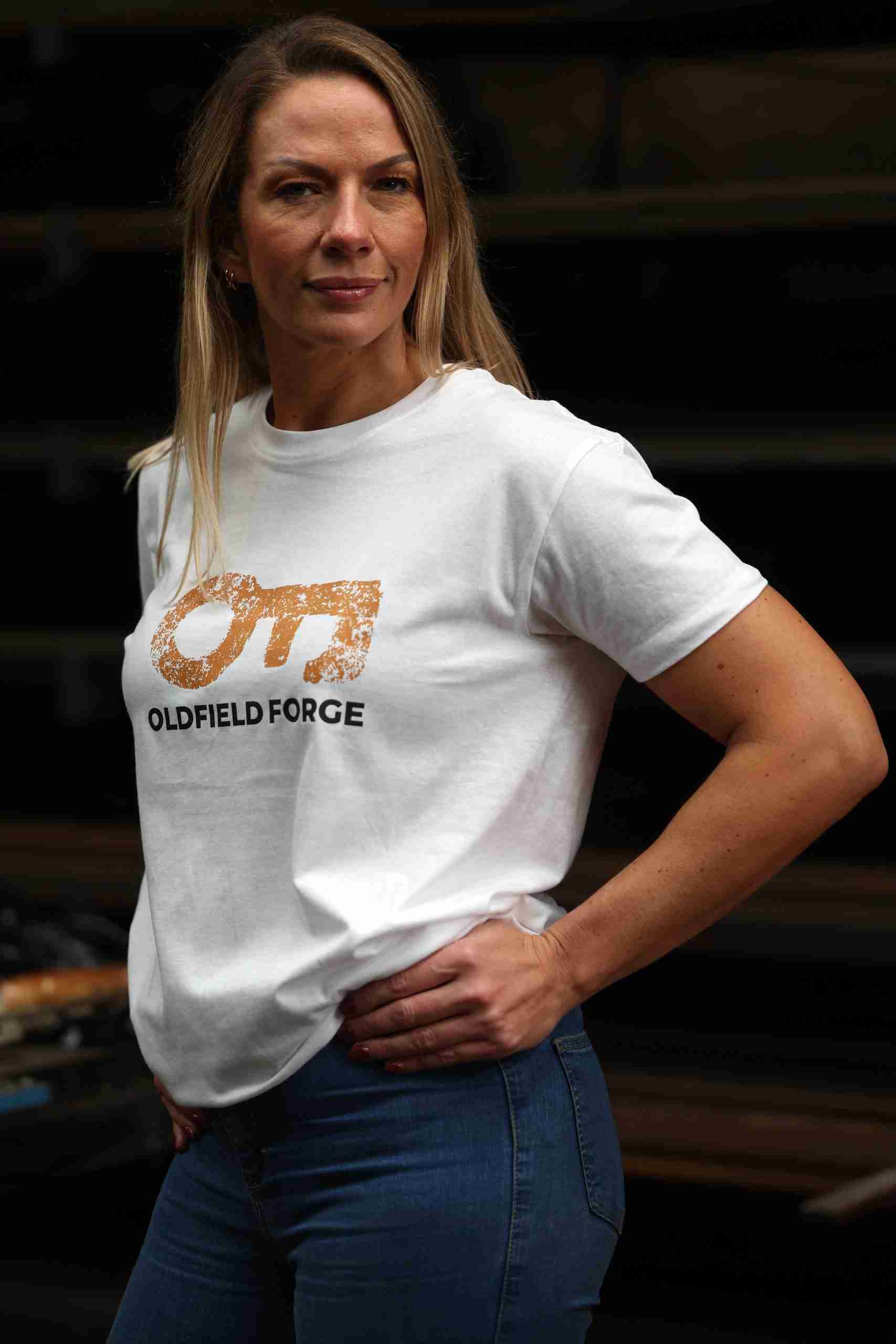 White t-shirt with logo branding and leather patch detail.