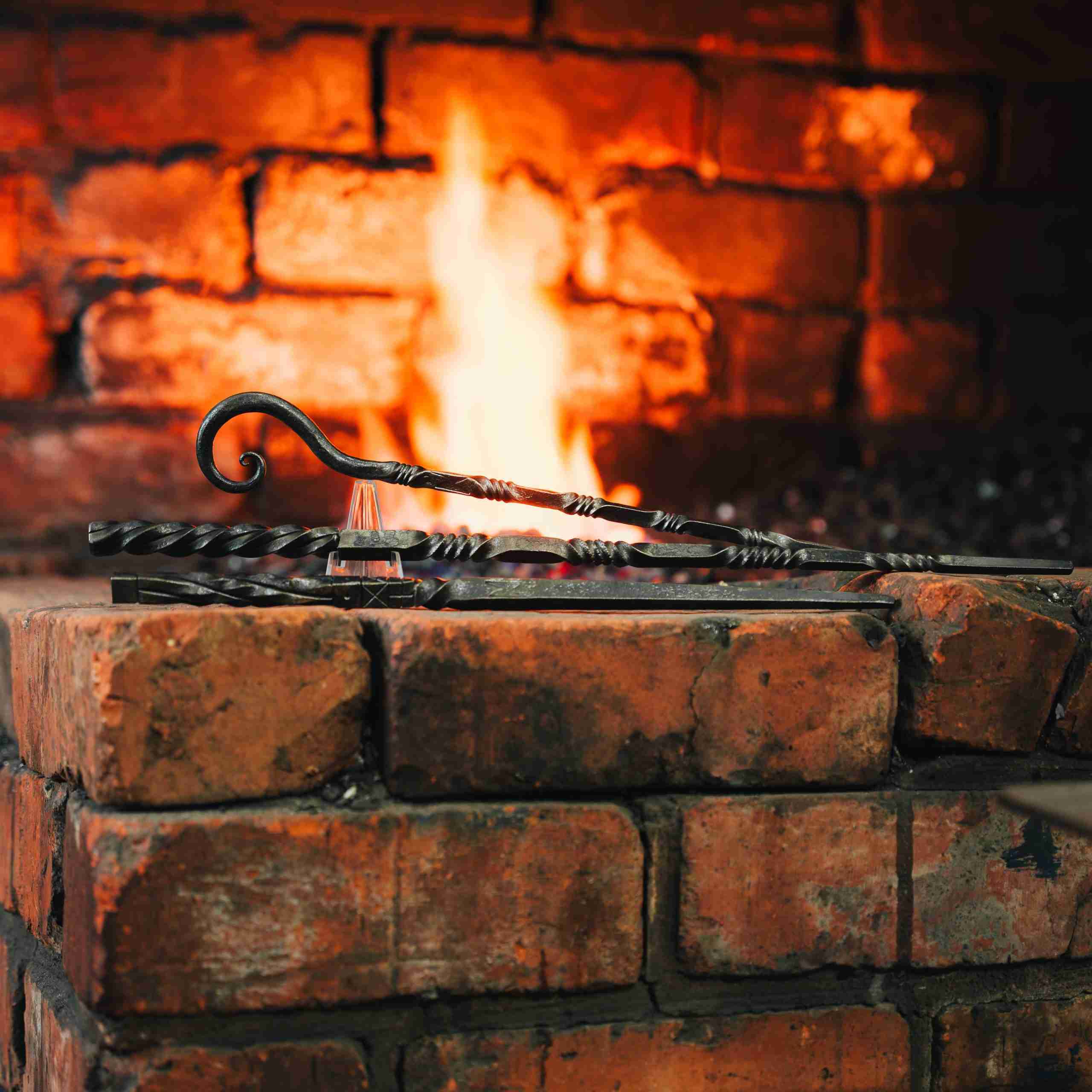 3 wand designs in front of a forge fire