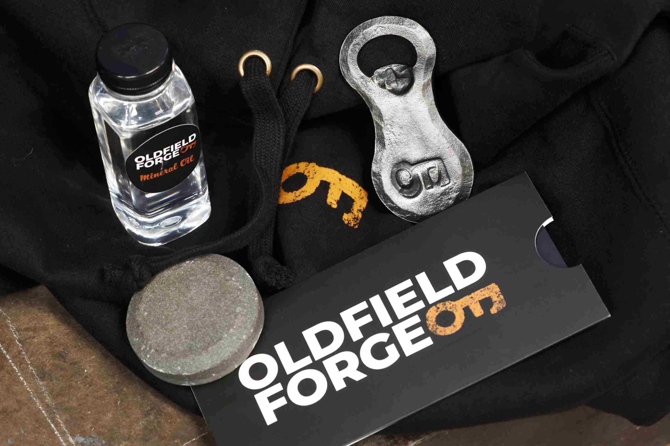 Oldfield forge hoody, circle sharpening stone, handmade logo bottle opener, postal vouchers and mineral water